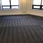 This is a photo of a grey office carpet that has just been professionally steam cleaned works carried out by Hendon Carpet Cleaning