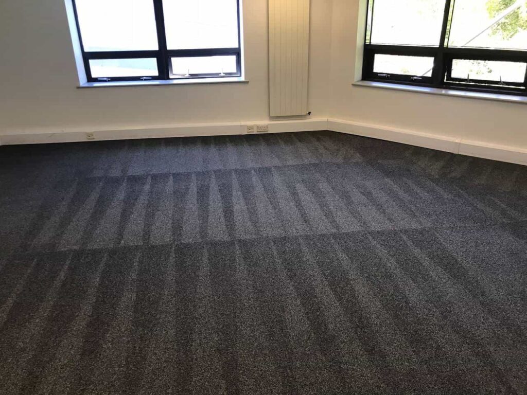 This is a photo of a grey office carpet that has just been professionally steam cleaned works carried out by Hendon Carpet Cleaning