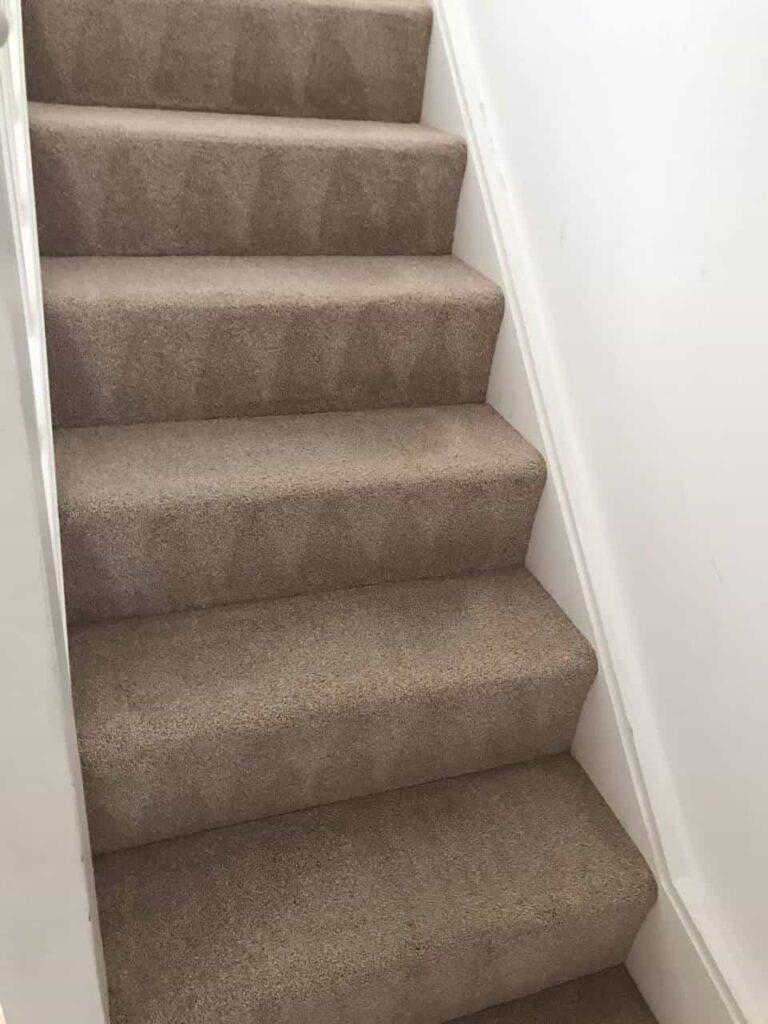 This is an after photo of a staircase with a beige carpet that has been cleaned works carried out by Hendon Carpet Cleaning